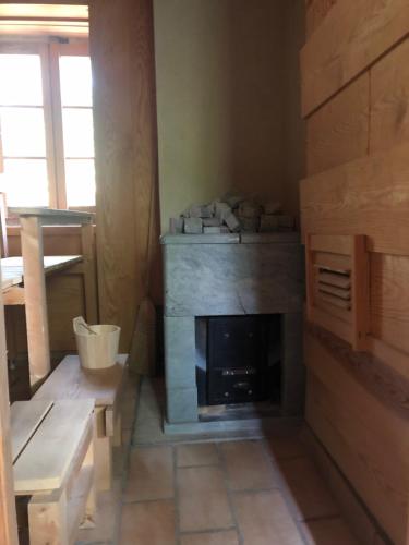 a living room with a fireplace in the corner at Gite du grand cèdre in CampÃ´me