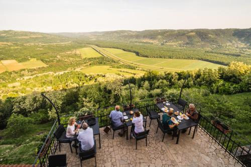 a group of people sitting at a table on a balcony at Villa Borgo B&B in Motovun