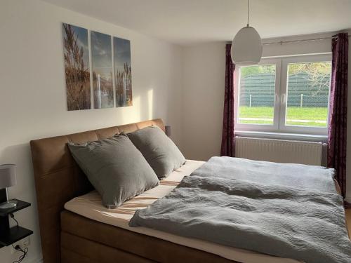 a bed with a blanket on it in a bedroom at Ferienwohnung Welk in Grömitz