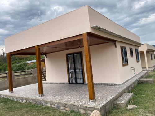 a small house with a large roof at Cabañas de Dario, Divino Tesoro in Alumbrera