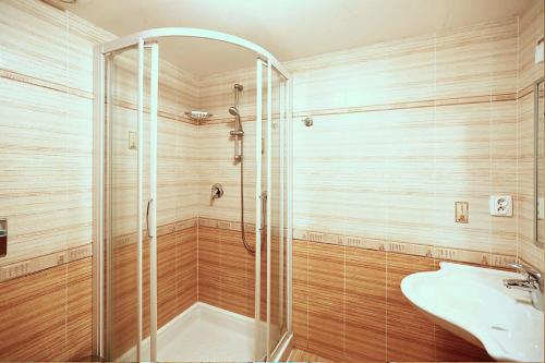 a bathroom with a shower and a sink at Miniresort AMULET in Hrubá Skála