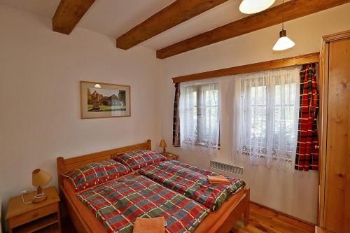 a bedroom with a bed and a window at Miniresort AMULET in Hrubá Skála