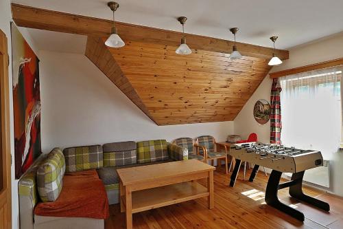 a living room with a couch and a table at Miniresort AMULET in Hrubá Skála