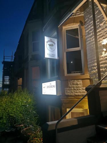 a house with two signs on the side of it at The Sanderling in Morecambe