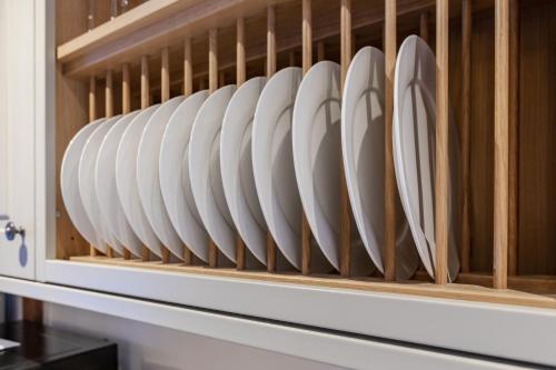 a rack of white plates in a microwave oven at Otters Abode in Blockley