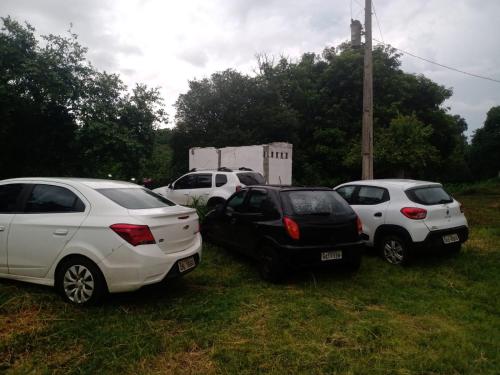 a group of three cars parked in a field at Bonserá do Madeira in Lavras