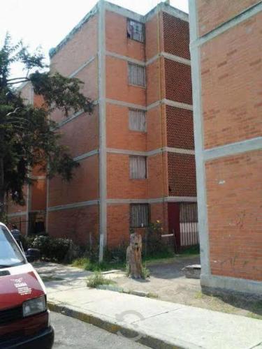 a fire hydrant in front of a brick building at Linas home in Toluca