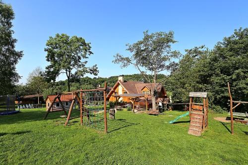 a group of playground equipment in front of a house at Miniresort AMULET in Hrubá Skála