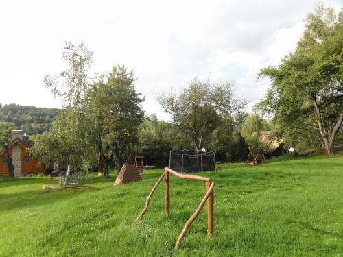 a park with a playground in a green field at Miniresort AMULET in Hrubá Skála