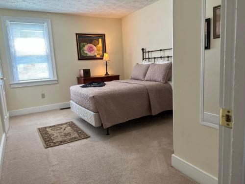a bedroom with a bed and a window at Extended Stays by Lee House Inn in Maysville