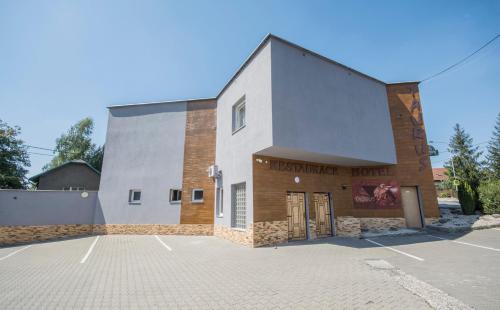 a building with a parking lot in front of it at Hotel Taurus in Ostrava