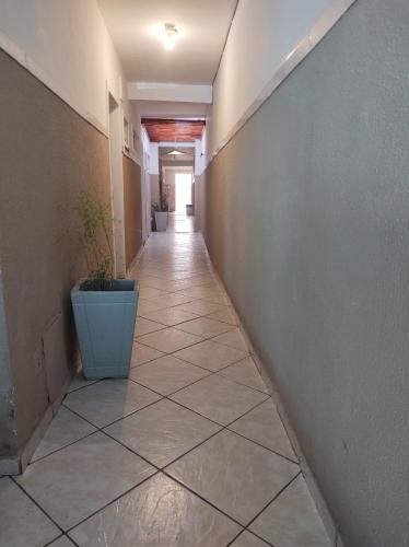 a hallway of an office building with a tile floor at Pousada nascente do sol in Macaé