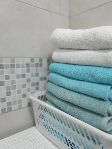 a pile of towels in a basket in a bathroom at Diamond M Apartment in Bihać