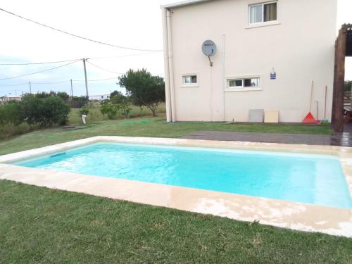 a swimming pool in the yard of a house at La Quijotada in Punta Colorada