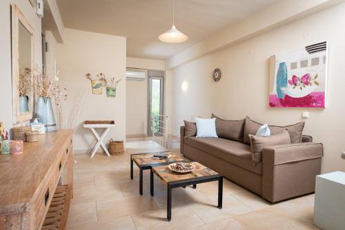 a living room with a couch and a table at Aelia Home Suites in Marathopoli