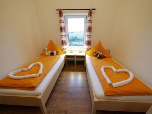 two beds with hearts on them in a room at Ferienwohnung 4 in Ochsenhausen