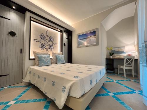 a small bedroom with a bed in a room at Suite Villa Domos in Porto Pino