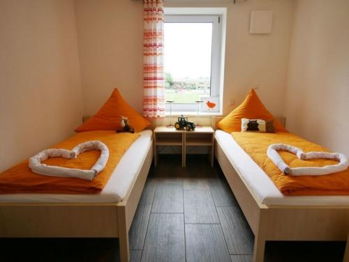 two beds in a room with hearts shaped beds at Ferienwohnung 2 in Ochsenhausen