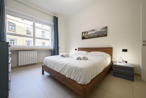a bedroom with a large bed with two towels on it at Via Niccolò Tommaseo 4 - appartamento 2 in Naples