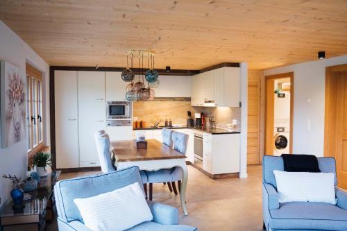 a kitchen and living room with a table and chairs at Traumwohnung auf kleiner Pferdefarm in Thun
