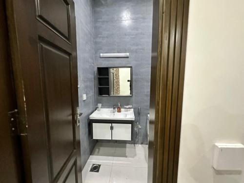a bathroom with a sink and a mirror at Bahria Residency in Rawalpindi