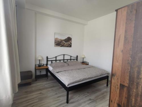 A bed or beds in a room at Apartmán LUX