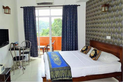 a bedroom with a bed and a large window at Kandy Supreme Hotel in Kandy