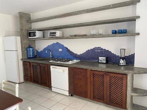 a kitchen with a sink and a counter top at Bahia Dorada 1 habitación in Pampatar