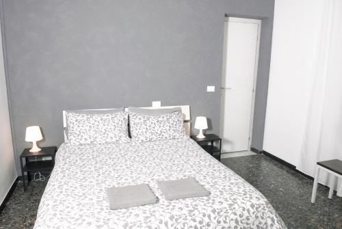 a bedroom with a large white bed with two pillows at La Pergola Private Parking in Vezzano Ligure