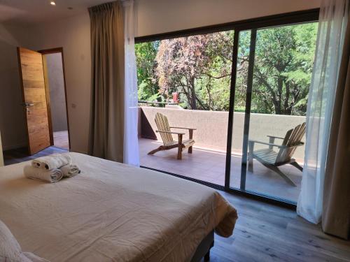 a bedroom with a bed with a stuffed animal on it at Casa Lopez in Chacras de Coria