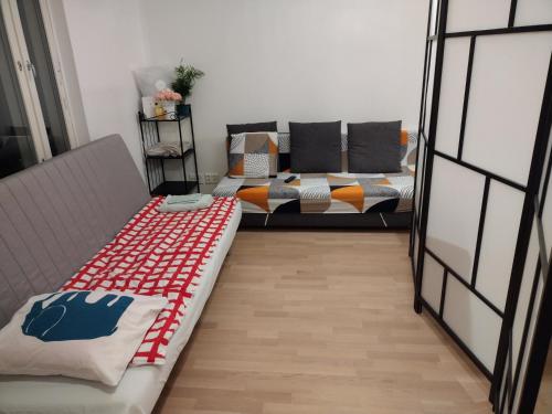 a living room with a couch and a table at Helsinki Private-Yksityinen-Частный Room in Shared Apartment into Airport-BusTrain Station-University in Helsinki