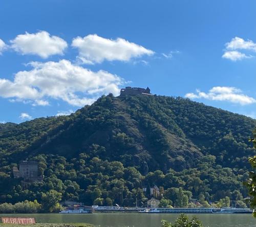 a hill with a castle on top of it at Fotel Dunakanyar in Nagymaros