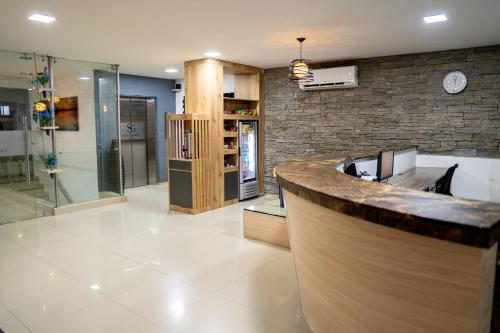 a kitchen with a counter and a glass shower at Hotel San Gabriel in Barrancabermeja