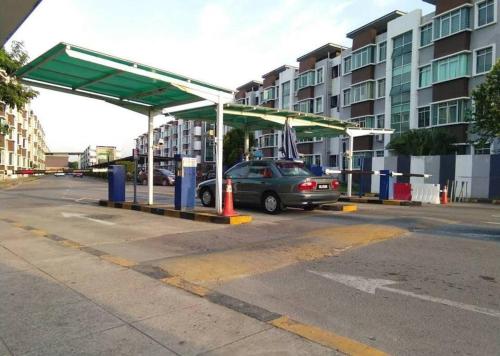 a car parked at a gas station in a parking lot at Cybercity Ph1 near KKIA by Family Homestay in Donggongon