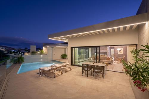 a house with a swimming pool and a patio at Salobre Oasis Suites in Salobre