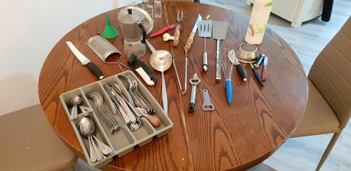 a wooden table with utensils on top of it at Family apartment in Riccione, free bikes in Riccione