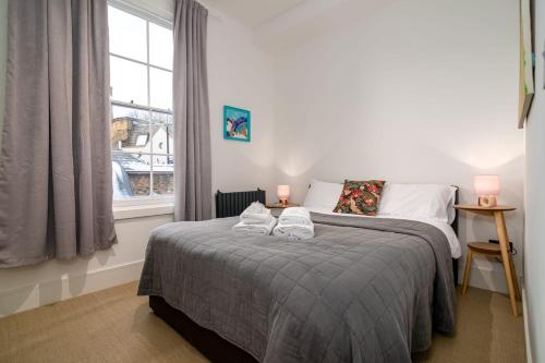 a bedroom with a bed with two towels on it at GuestReady - Luxury Central London Apartment in London