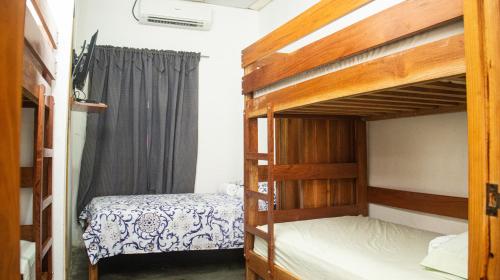 a bedroom with two bunk beds and a window at Hostal Mi Castillo in Mariabé