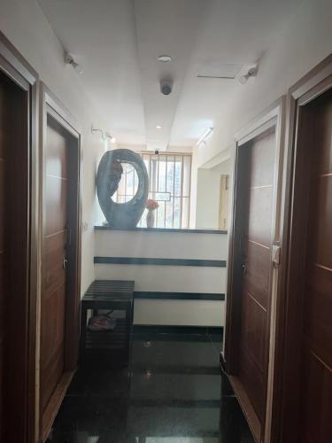 a hallway with blue and white stripes on the wall at Kamadhenu Residency Homestay & Service Apartment Coorg Madikeri in Madikeri