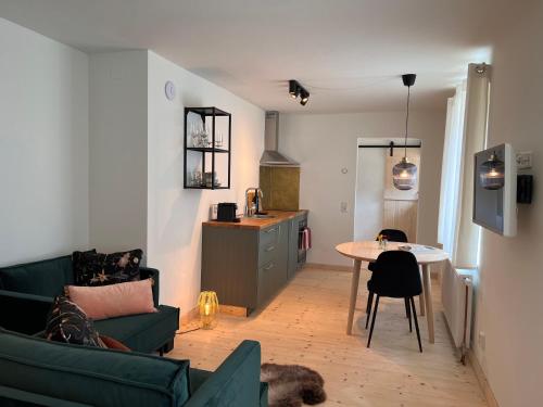 a living room with a couch and a table at Ankogel Lofts Mallnitz in Mallnitz