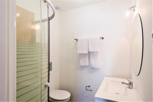 a bathroom with a shower and a toilet and a sink at Vale do Lobo Apartment B in Vale do Lobo