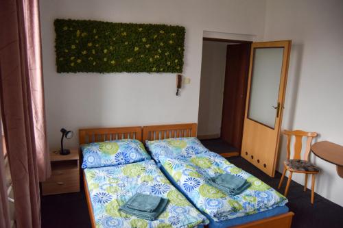 a bedroom with a bed with two pillows on it at Penzion Betty in Okounov