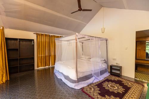 a bedroom with a canopy bed in a room at Dreamcatcher By Brifton Hotel And Resorts in Palolem
