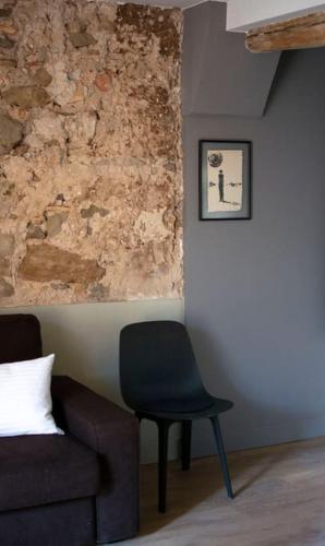a living room with a chair and a couch at Cal Punté - Anita in Ponts