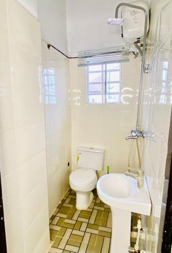 a bathroom with a toilet and a sink at Lovely Studio apartment at Ajah - Maria in Iranla