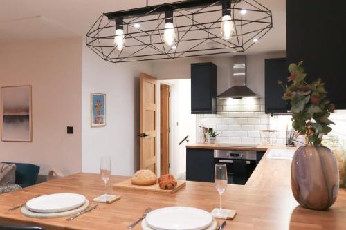 a kitchen with a wooden table and a dining room at Cozy 1BR in Headington Oxford w off-road Parking in Oxford