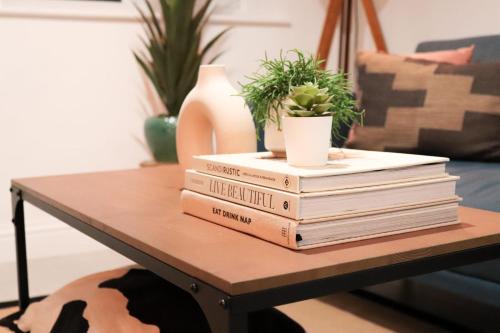a stack of books sitting on a coffee table at Cozy 1BR in Headington Oxford w off-road Parking in Oxford