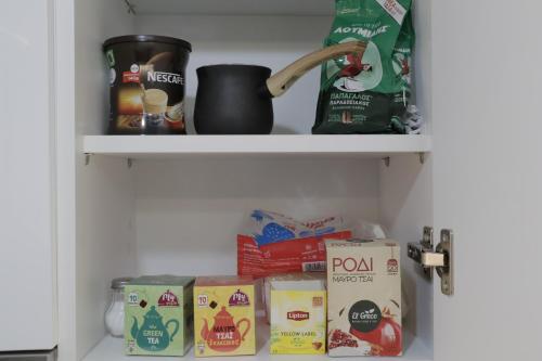 a pantry shelf with food and other food items at Helen's Little Castle free private parking in Thessaloniki