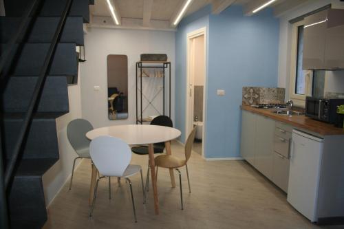 a kitchen with a table and chairs in a room at Valina Apartments in Catania