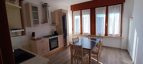 a kitchen with a table and chairs in a room at A casa di Mirco in Viverone